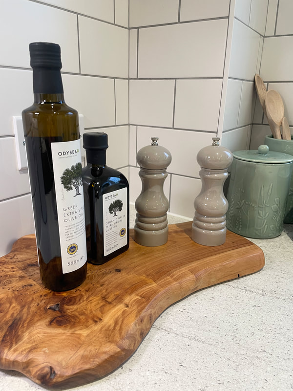olive oil bottles and salt and pepper mills on a wooden board at churchill retirement living