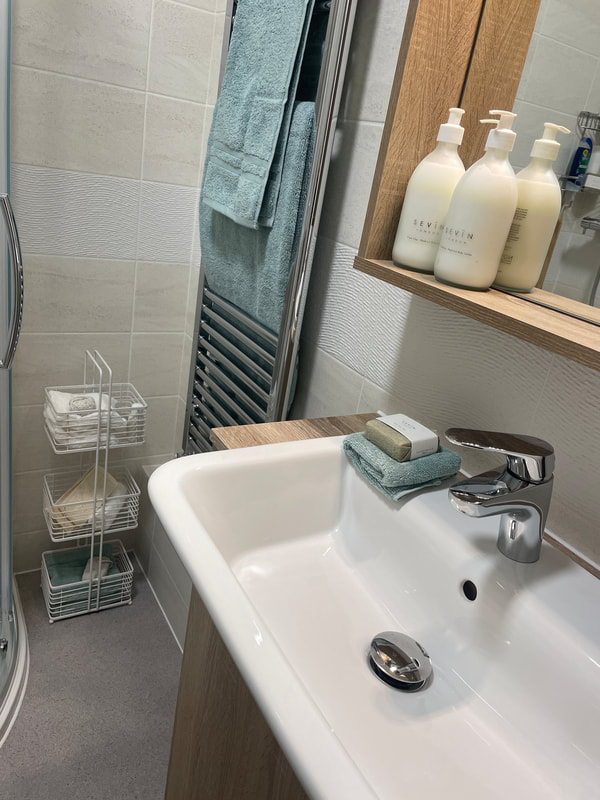 the ensuite bathroom at churchill retirement living - showing the wash hand basin and towels.