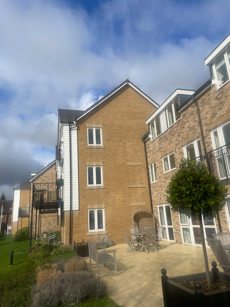 the communal gardens at churchill retirement living, with blue skies