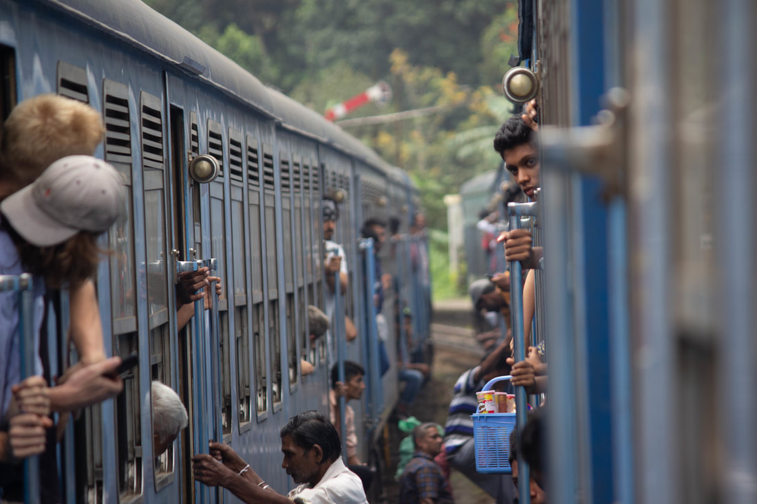 lots of people hanging out of trains in sri lanka