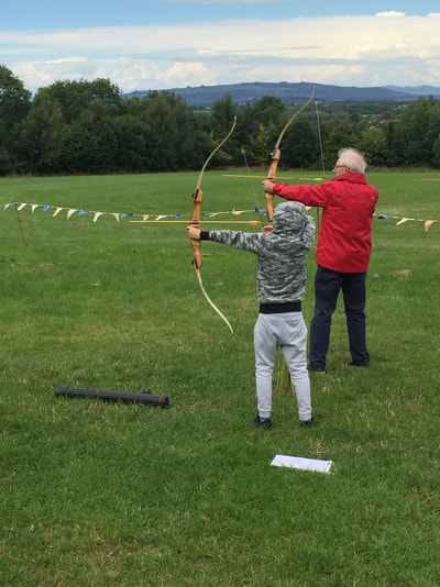 boy and grandfather archery