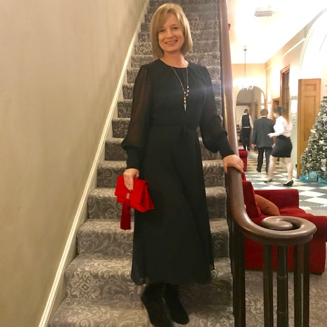 wearing a black dress from boden for a winter wedding