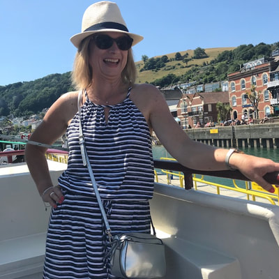 woman in hat on boat river dart