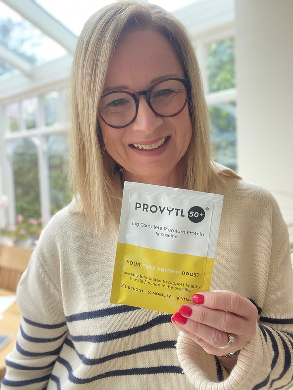 provytl 50+ best protein powder, michelle is holding a bright yellow and white protein powder sachet
