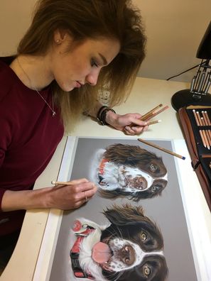 Sophie Fois artwork drawing a picture of two spaniel dogs