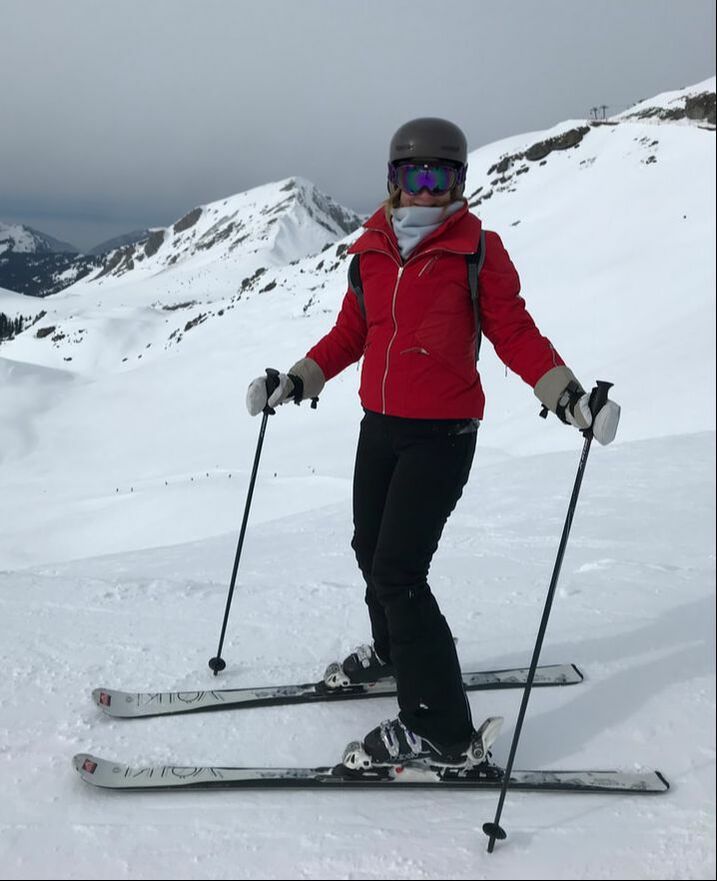 red ski jacket on ski slopes