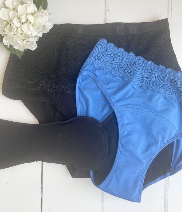 flatlay of two pairs of incontinence pants in blue and black from modibodi