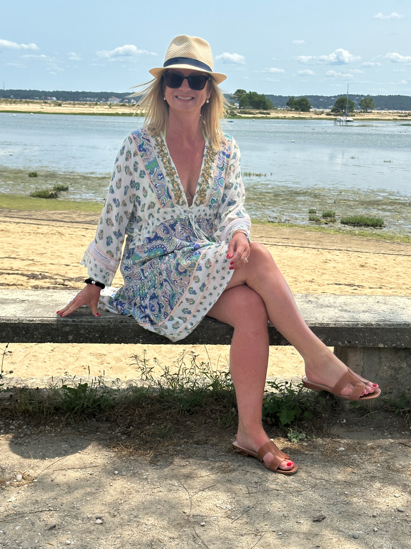 michelle sitting on a bench at cap ferret