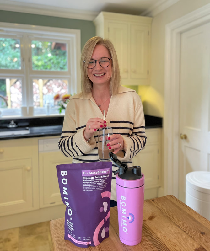 Woman in kitchen with the MenoShake from BOMIMO, meal replacement shake