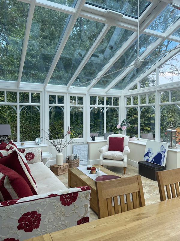 conservatory with red and cream sofa | interior designer buckinghamshire