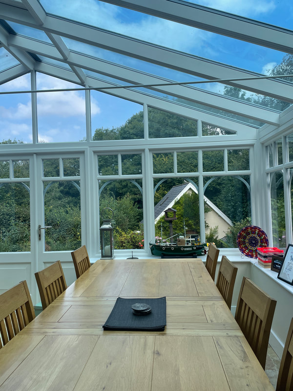 large oak table in conservatory | interior designer buckinghamshire