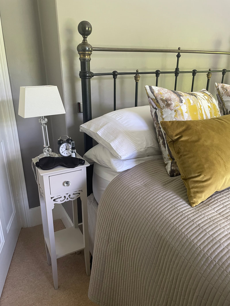 bedside table bed and clock | how can i sleep better during menopause