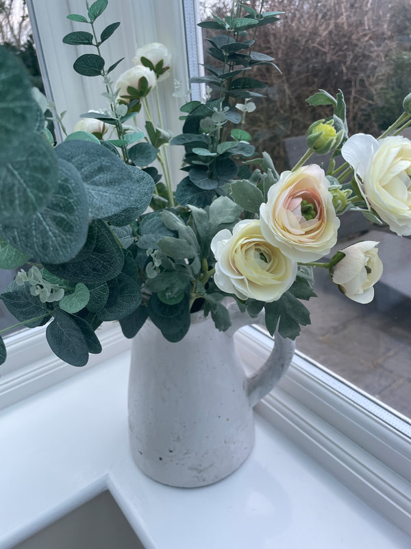 faux flowers on conservatory shelf