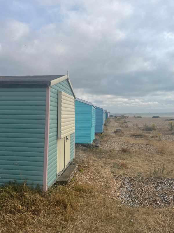 Blue and cream beach huts at Littlestone in Kent