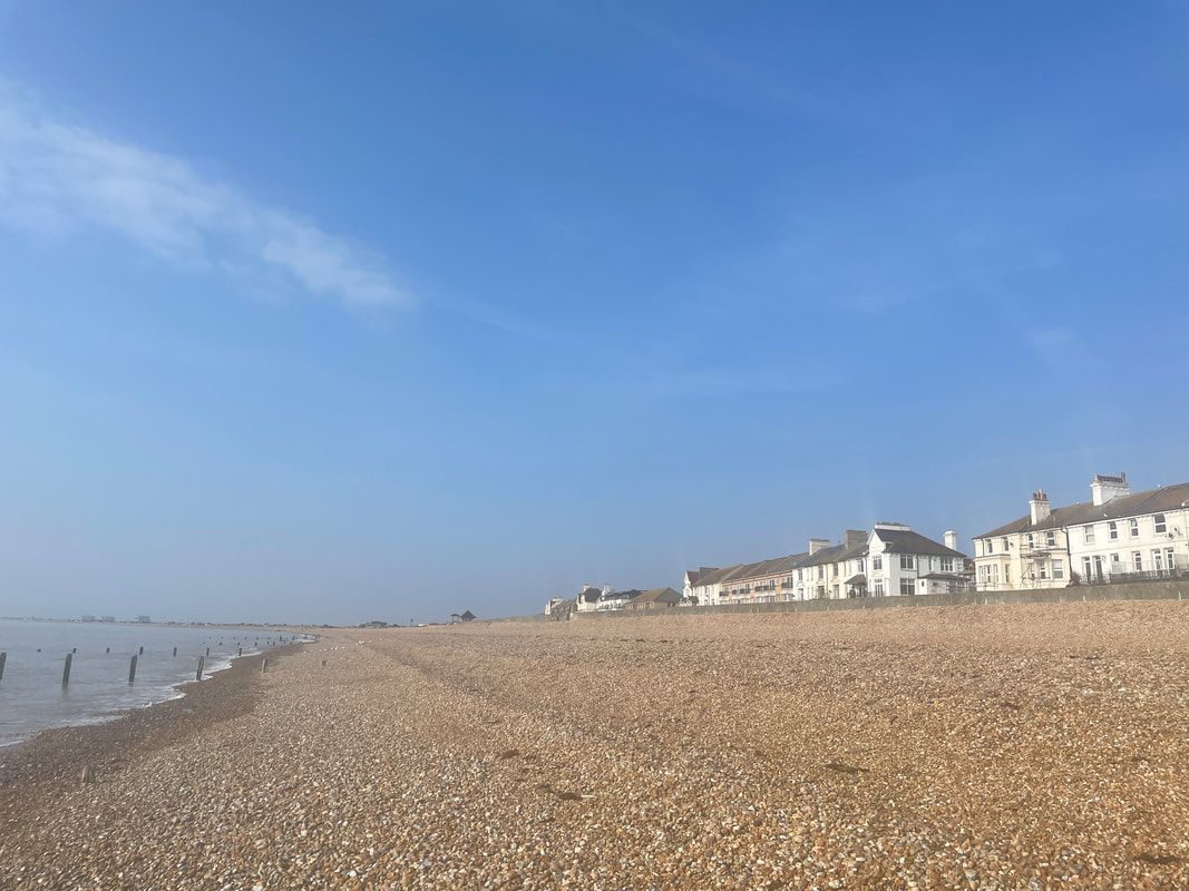 Beachside apartment with seaview overlooking the shingle beach at Littlestone in Kent, shingle beach and blue skies