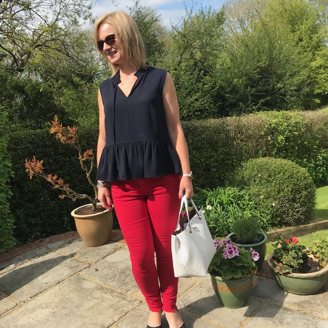 woman in red jeans in garden