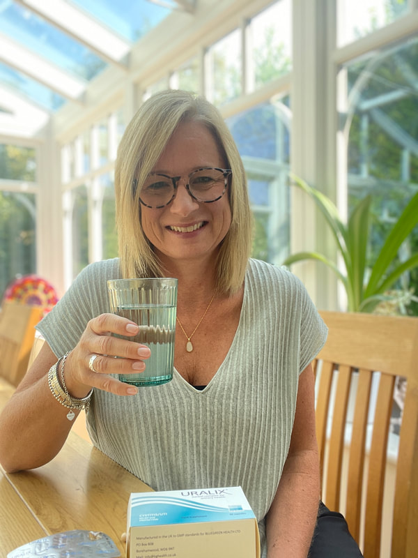 sitting with glass of water | uralix | preventing bladder infections