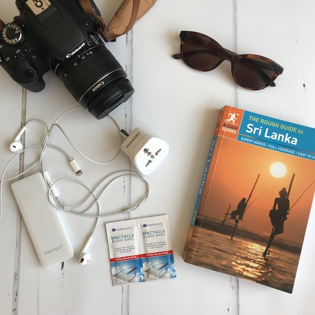 flat lay camera travel book sunglasses