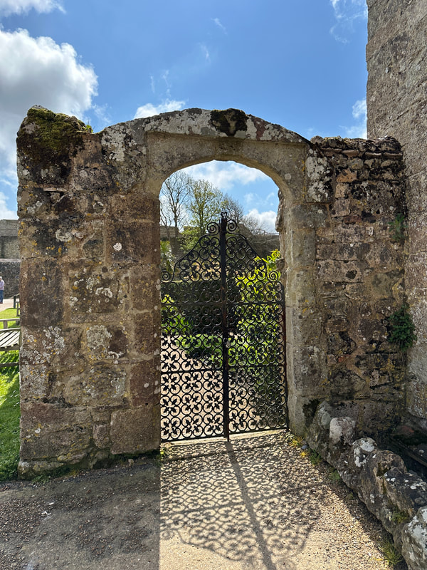 looking through the iron gate into princess beatrice garden at carisbrooke castle