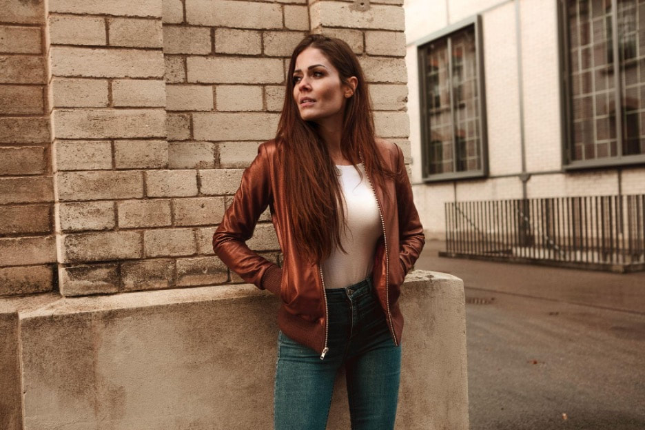 women wearing a brown leather bomber jacket