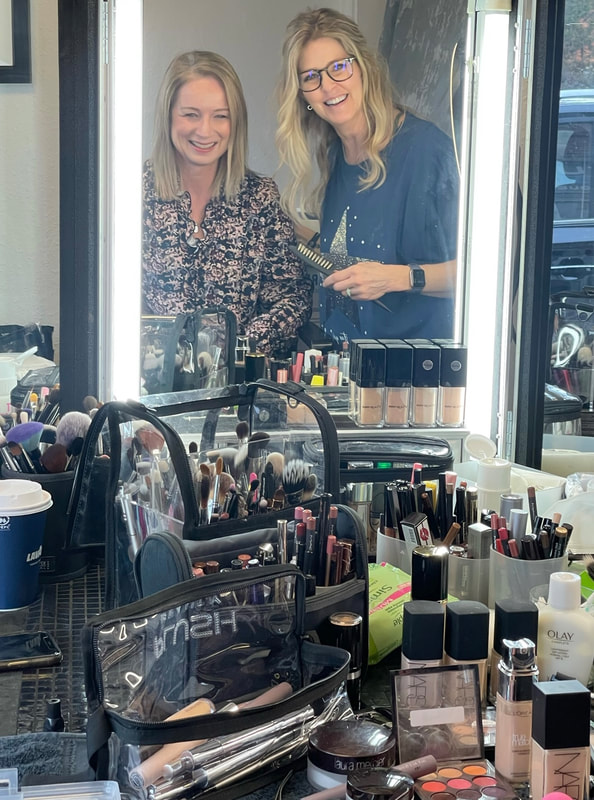 Michelle and Joanne are looking in the makeup mirror admiring makeup for women over 50