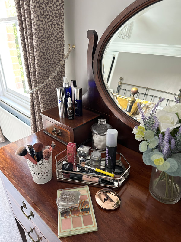 Michelle's makeup collection on her mahogany dressing table