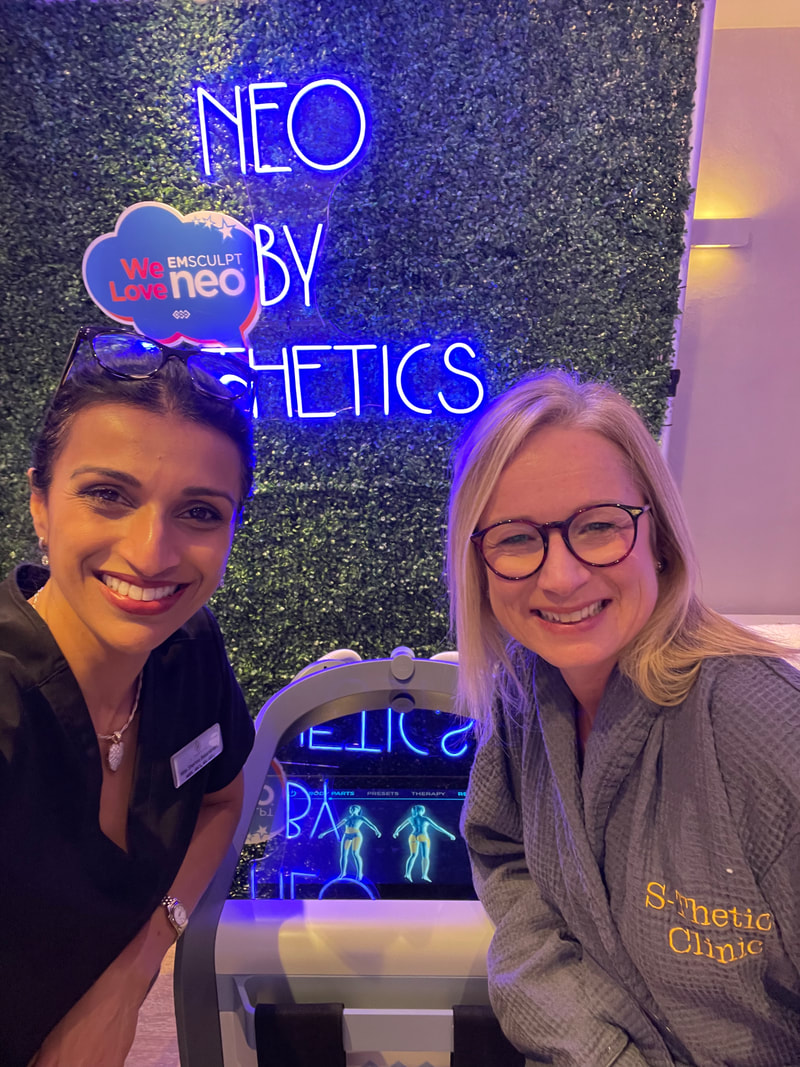 Miss Sherina Balaratnam and Michelle in front of the EMSculpt NEO sign at S-Thetics