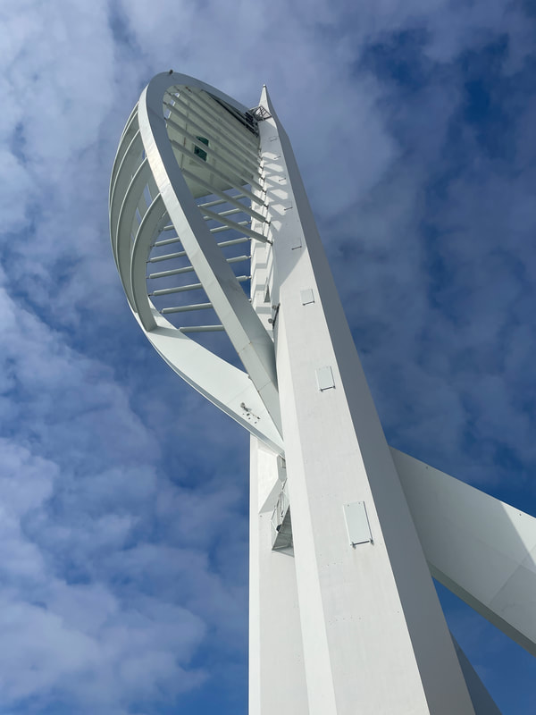 looking up at the spinnaker tower, portsmouth with blue sky and fluffy white clouds
