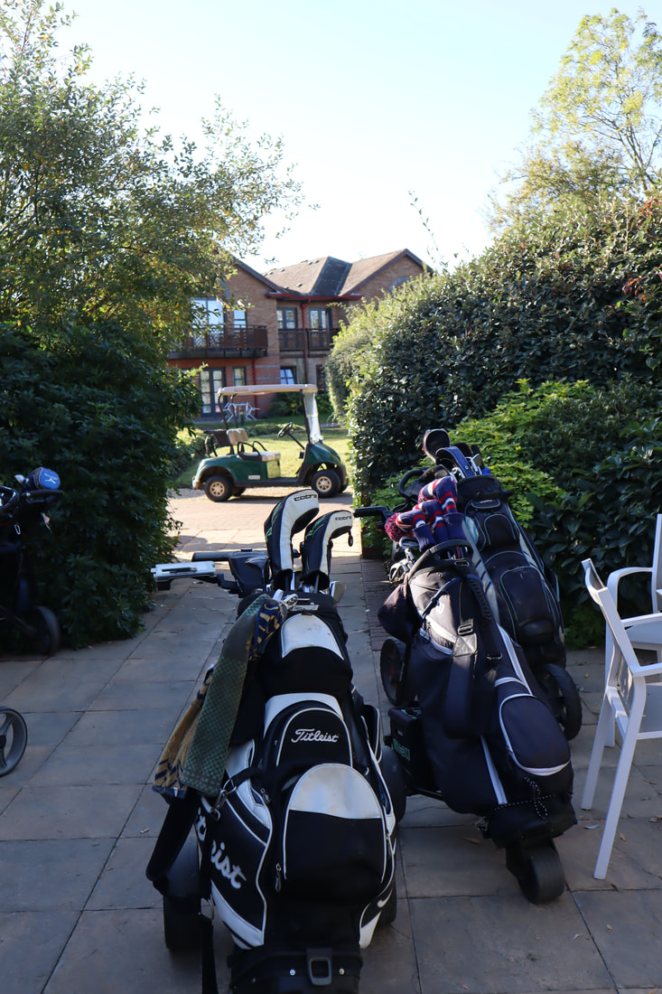 two golf bags and a golf buggy at the golf course at potters resorts five lakes
