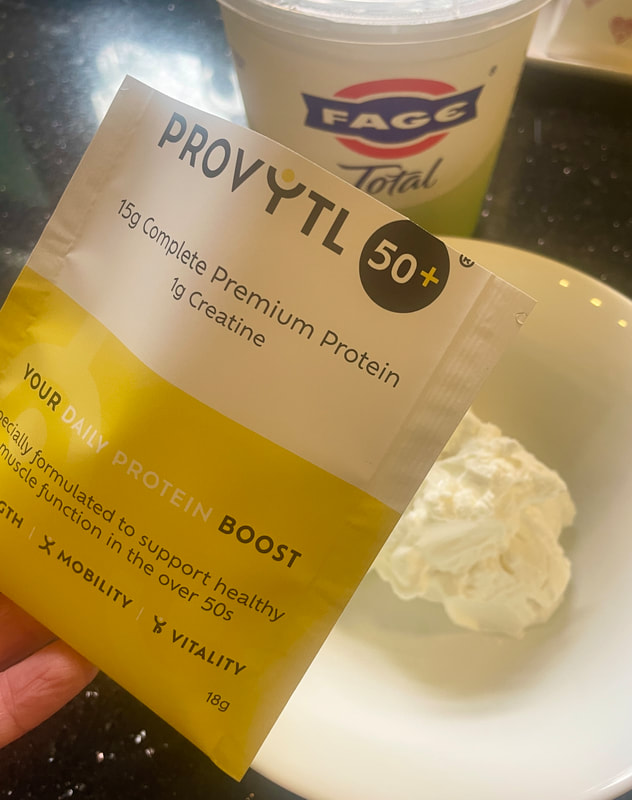 an open sachet of provytl 50+ being added to fage total yoghurt in a white bowl