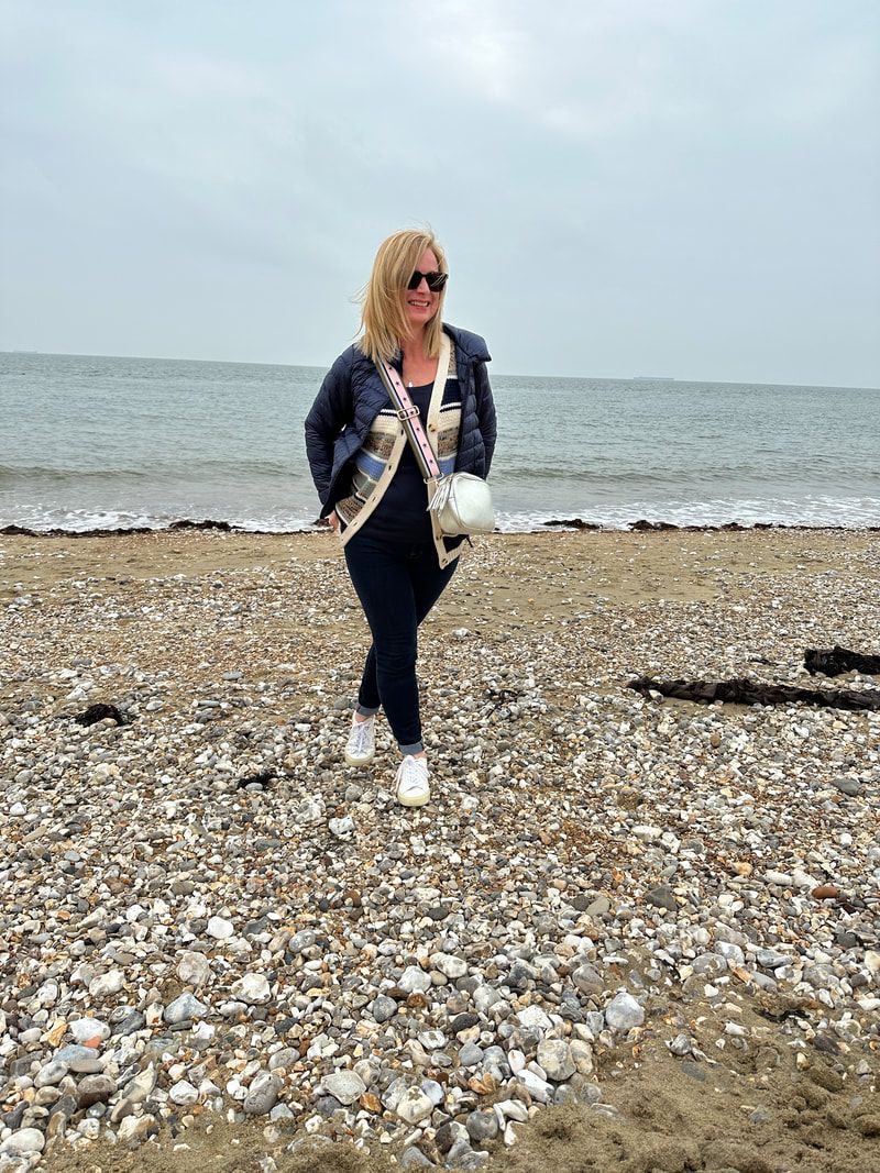 michelle is wearing an outfit from cotton traders and is walking along the shingle beach at ventnor on the isle of wight