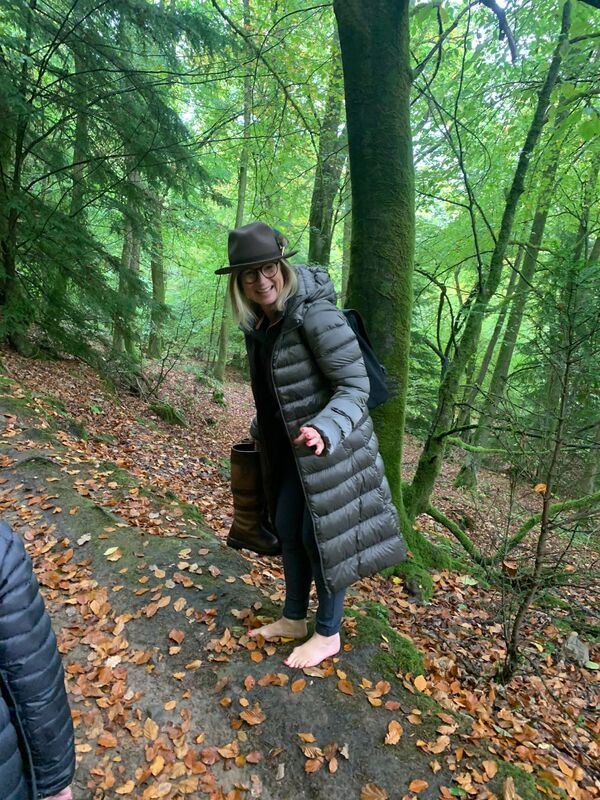 michelle enjoying walking barefoot for the forest bathing experience at hill farm in tintern