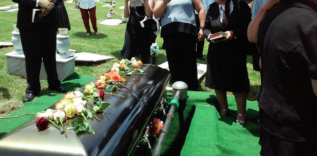 funeral, relatives at graveside | 5 reasons why people put off writing a Will